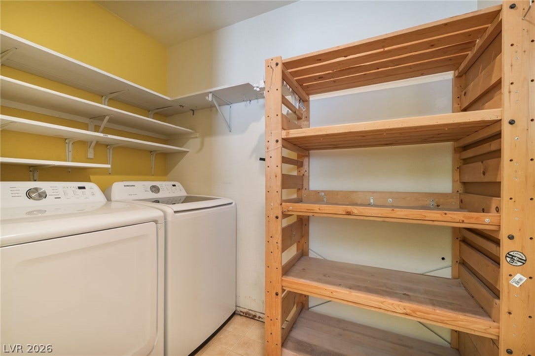 769 Salt Flats Circle, Henderson, NV 89011 A functional laundry area features overhead wall shelving alongside a large wooden storage unit.
