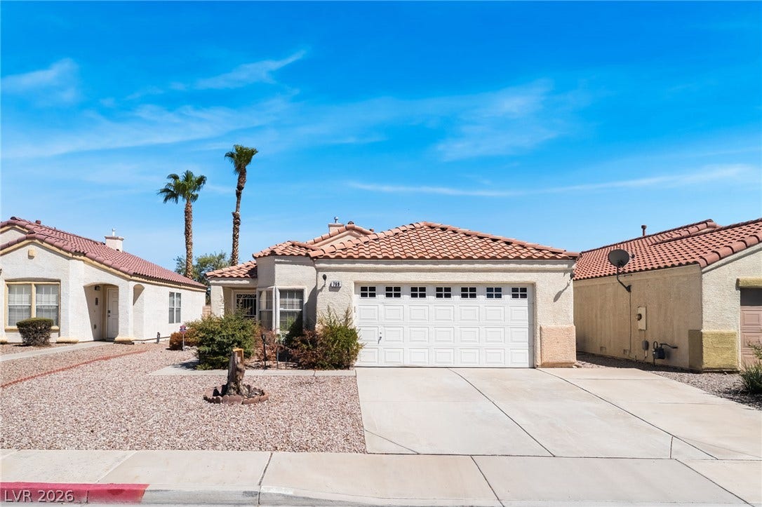 769 Salt Flats Circle, Henderson, NV 89011 Spanish tile roofing and a concrete driveway define this classic suburban exterior.