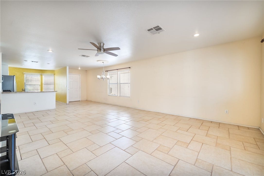 769 Salt Flats Circle, Henderson, NV 89011 Gleaming tile floors stretch across a versatile, sunlit living area perfect for custom layouts.