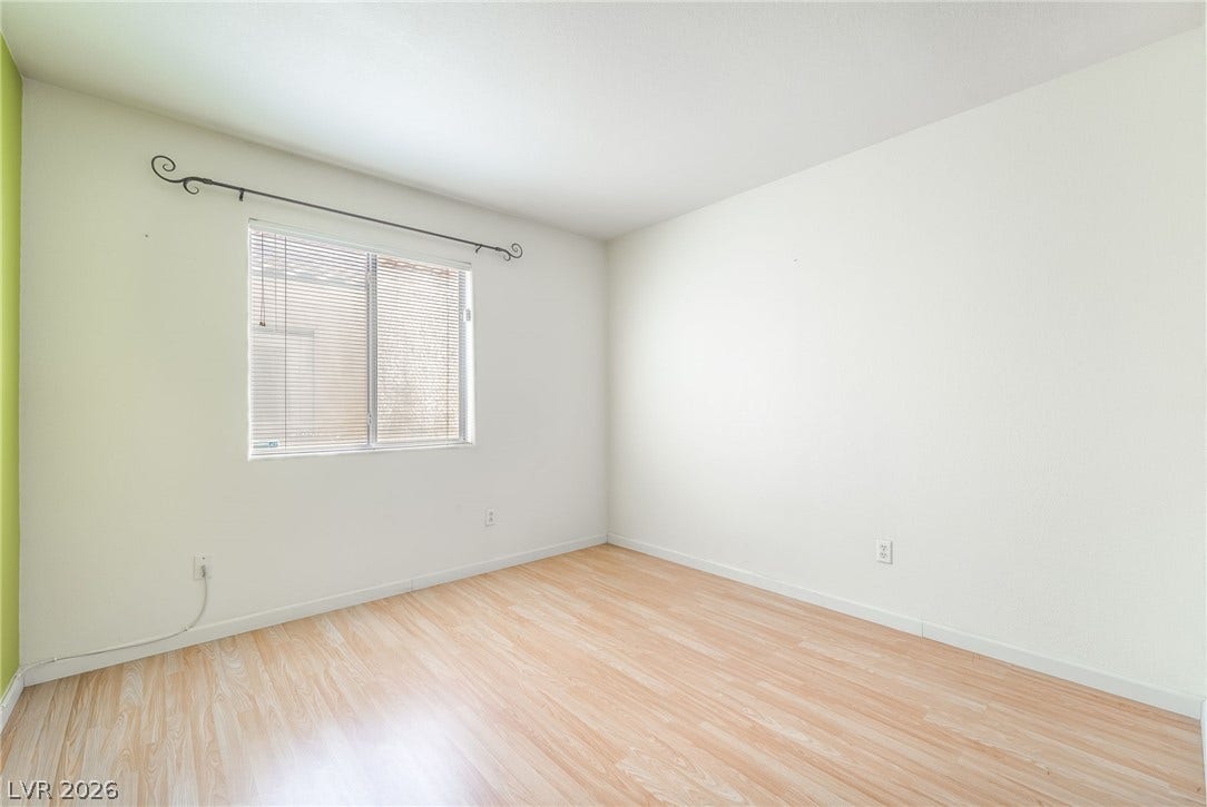 769 Salt Flats Circle, Henderson, NV 89011 Smooth wood-look flooring and a wide window define this versatile secondary bedroom space.