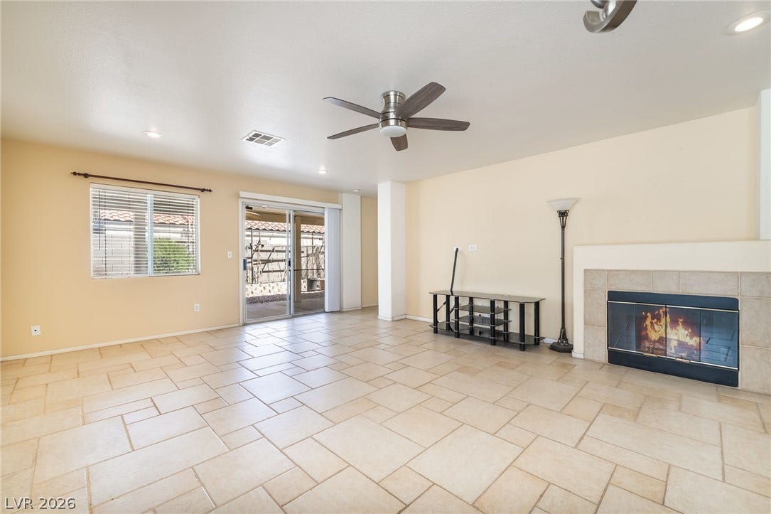 769 Salt Flats Circle, Henderson, NV 89011 Tiled flooring and a classic fireplace anchor this open living area.
