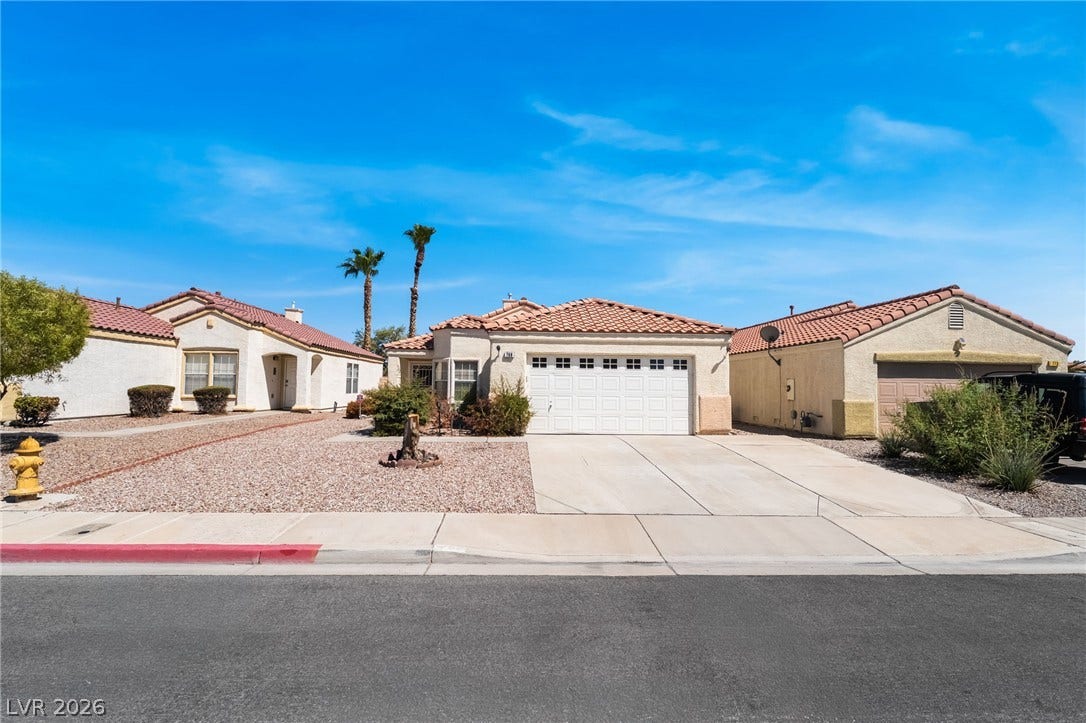 769 Salt Flats Circle, Henderson, NV 89011 Spanish tile roofing and a concrete driveway define this classic suburban front exterior.