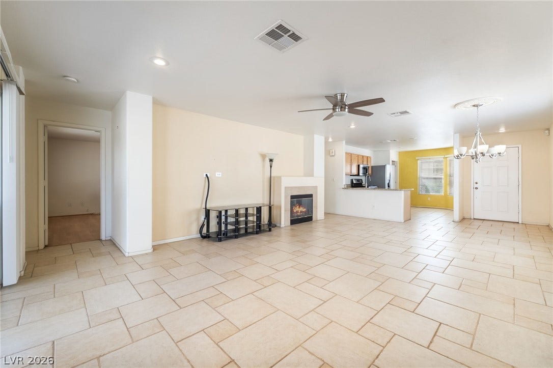 769 Salt Flats Circle, Henderson, NV 89011 Ceramic tile floors and a classic fireplace anchor this versatile living area.