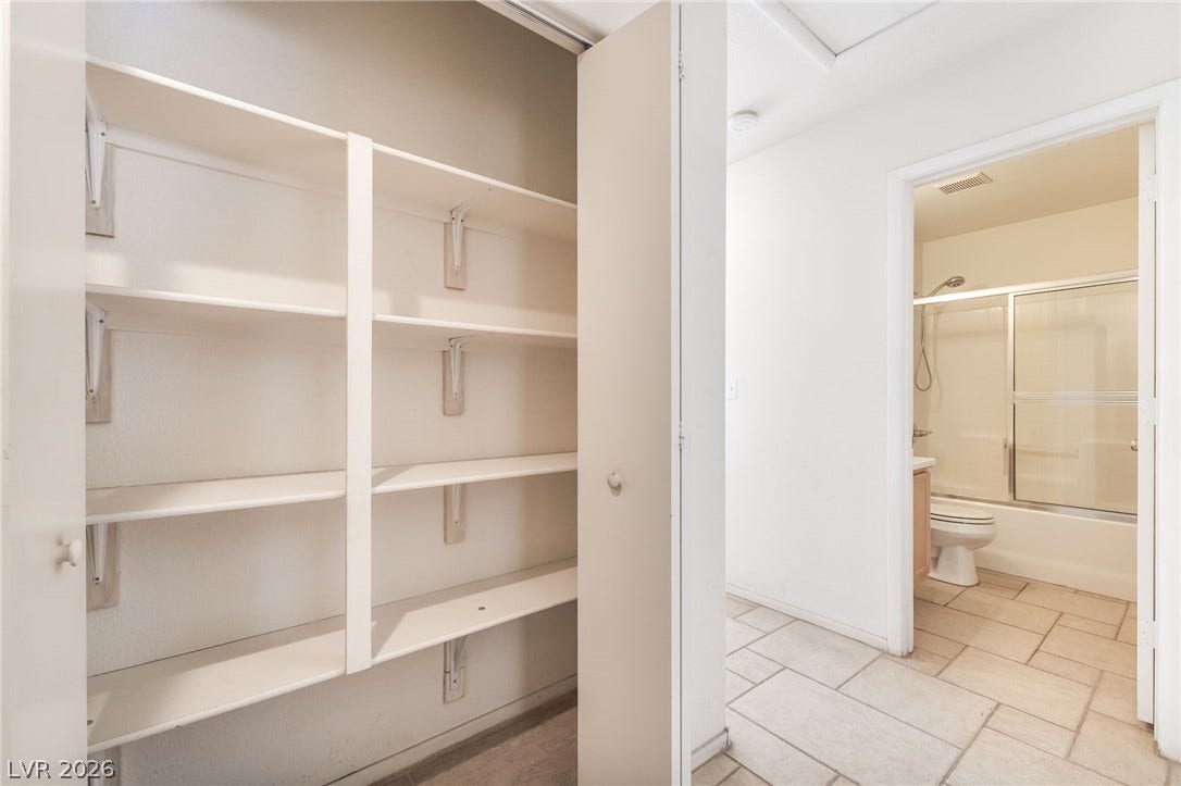 769 Salt Flats Circle, Henderson, NV 89011 Ample built-in shelving maximizes storage space near the tiled hallway and adjacent bathroom.