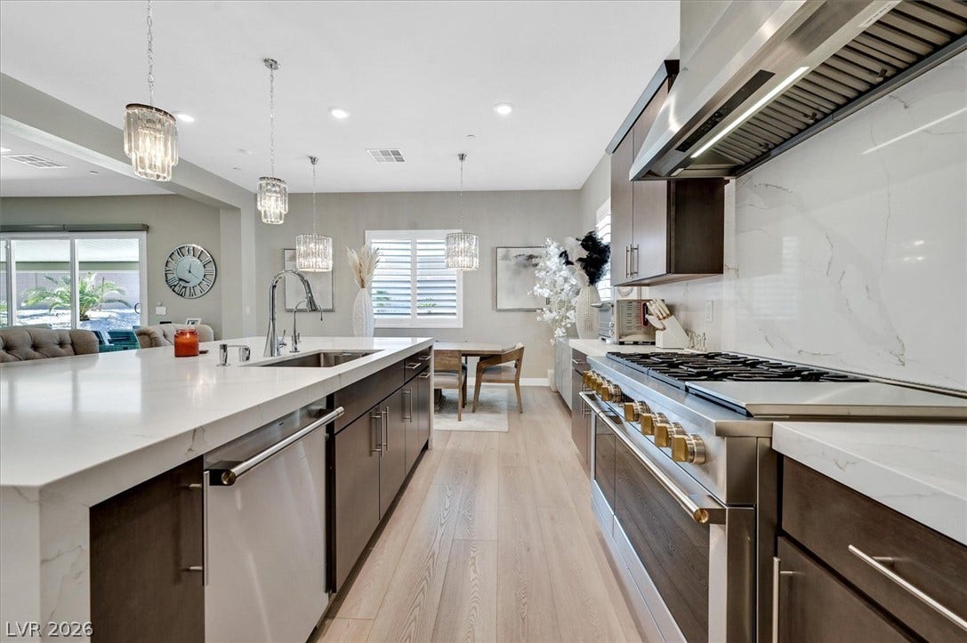2689 Pioneer Estates Court, Las Vegas, NV 89117 Polished stone countertops and seamless wood flooring anchor this contemporary culinary space.