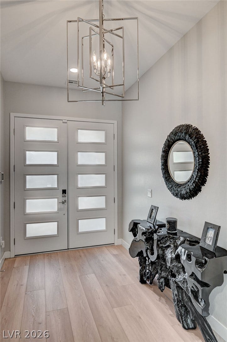 2689 Pioneer Estates Court, Las Vegas, NV 89117 Double entry doors with inset glass panels welcome visitors into this high-ceilinged foyer.