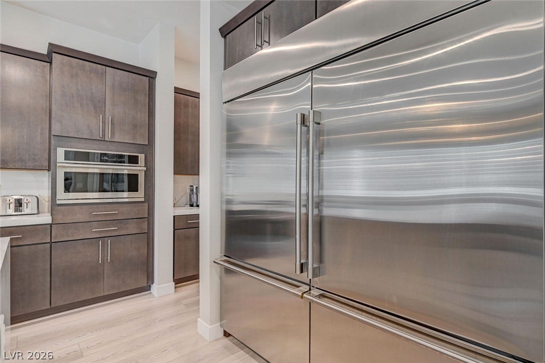 2689 Pioneer Estates Court, Las Vegas, NV 89117 Sleek contemporary cabinetry pairs with professional-grade stainless steel appliances and light wood flooring.