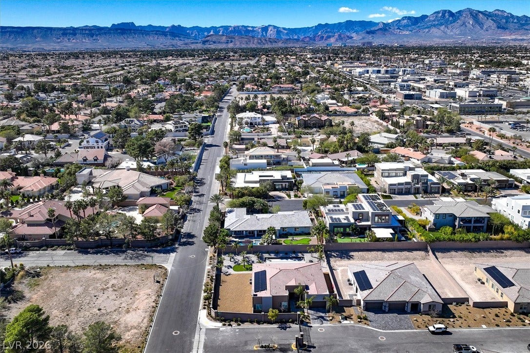 2689 Pioneer Estates Court, Las Vegas, NV 89117 Dramatic mountain ridges frame a sprawling suburban neighborhood connected by quiet paved streets.