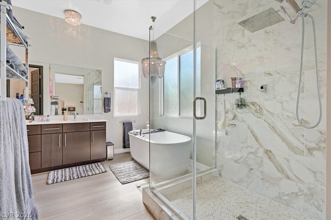 2689 Pioneer Estates Court, Las Vegas, NV 89117 Indulge in a spa-like atmosphere featuring a glass shower, soaking tub, and modern vanity.