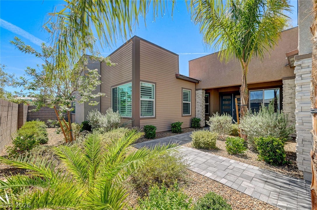 2689 Pioneer Estates Court, Las Vegas, NV 89117 Palm trees frame a paved walkway leading to this contemporary architectural design.
