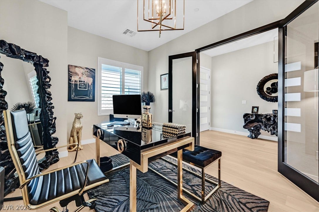2689 Pioneer Estates Court, Las Vegas, NV 89117 Double glass doors open to a bright workspace with light wood floors.