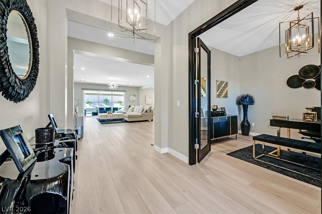 2689 Pioneer Estates Court, Las Vegas, NV 89117 Gleaming wood floors flow from the welcoming entryway into a bright open-concept living space.