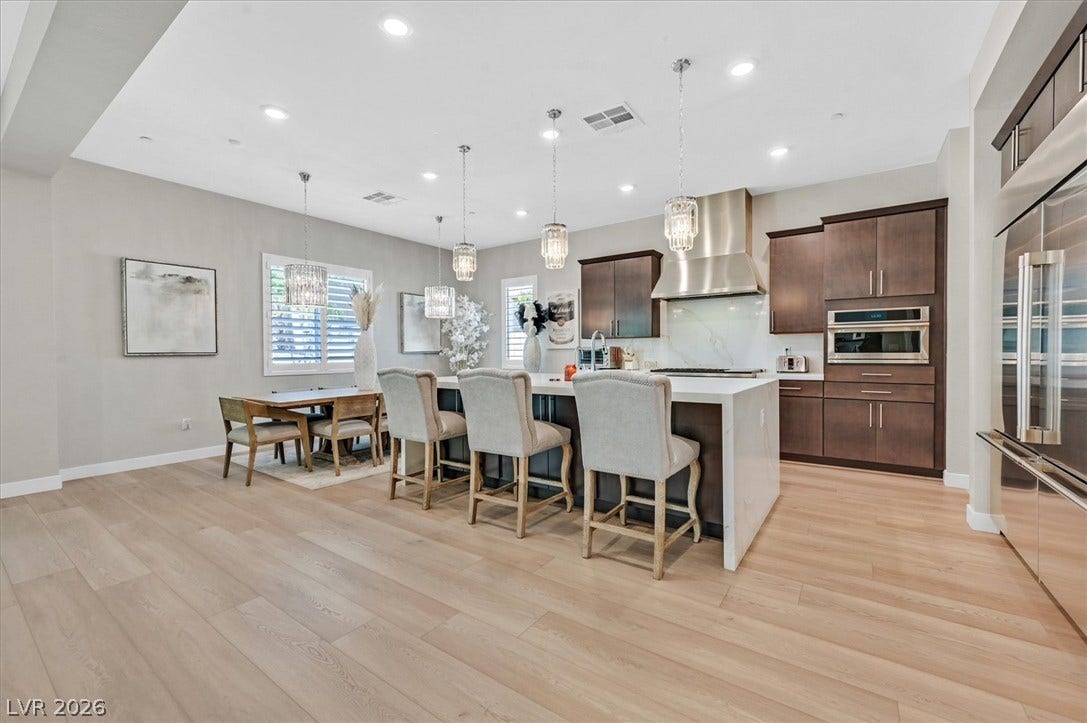2689 Pioneer Estates Court, Las Vegas, NV 89117 Warm wood flooring flows through this open culinary space configured with a central island.