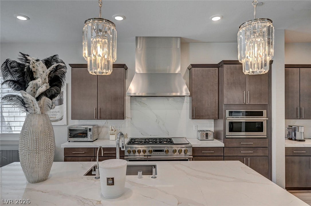 2689 Pioneer Estates Court, Las Vegas, NV 89117 Premium stone countertops pair elegantly with flat-panel wood cabinetry in this culinary space.