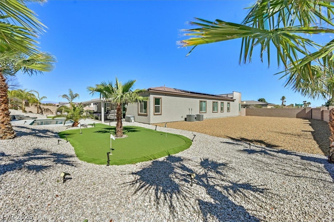 2689 Pioneer Estates Court, Las Vegas, NV 89117 An expansive gravel yard features a private putting green alongside the residence.