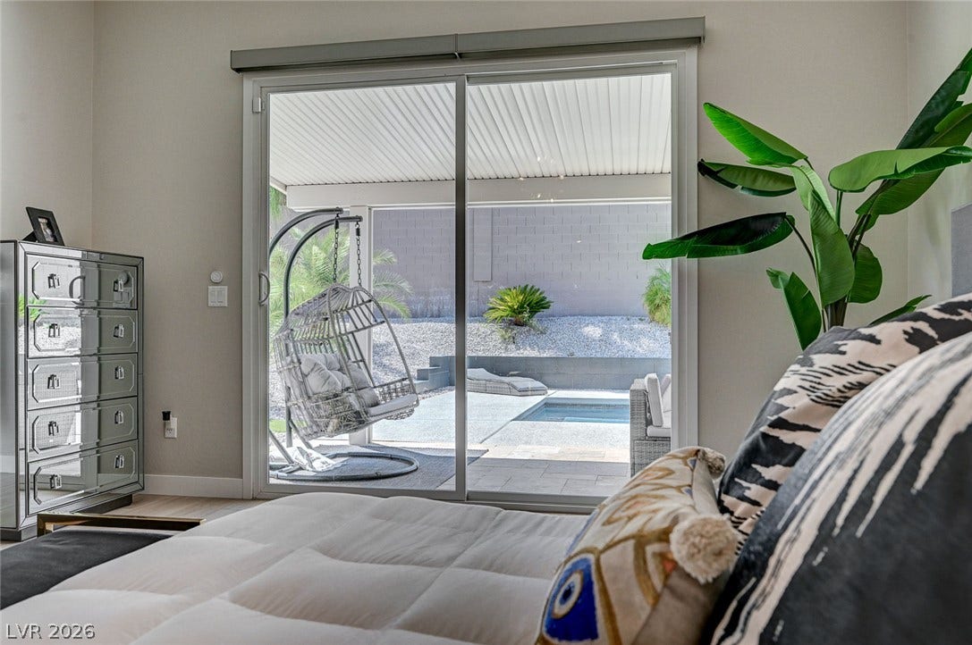 2689 Pioneer Estates Court, Las Vegas, NV 89117 Large sliding glass doors open directly from the bedroom to a private pool area.