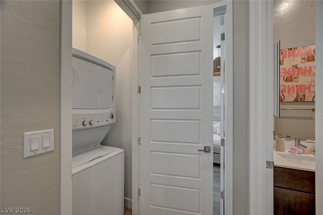 2689 Pioneer Estates Court, Las Vegas, NV 89117 A compact laundry closet features a stacked washer and dryer unit.