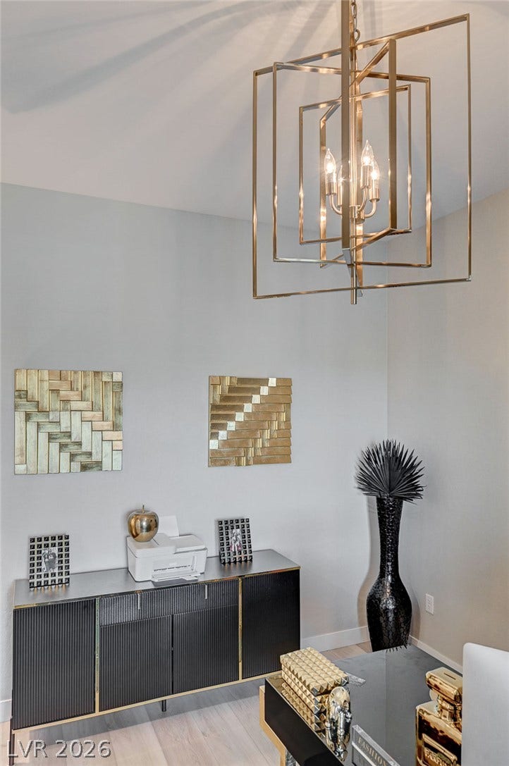 2689 Pioneer Estates Court, Las Vegas, NV 89117 Smooth walls and hardwood flooring define this contemporary home workspace corner.