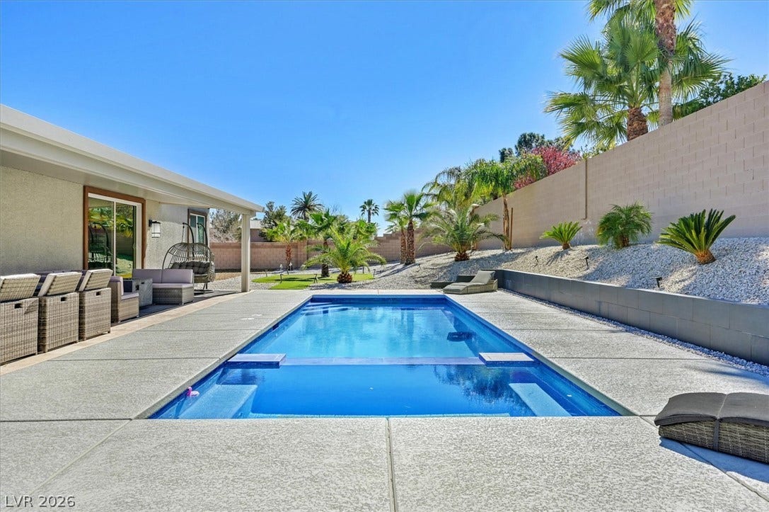 2689 Pioneer Estates Court, Las Vegas, NV 89117 An inviting backyard oasis centers around a pristine swimming pool surrounded by clean concrete decking.