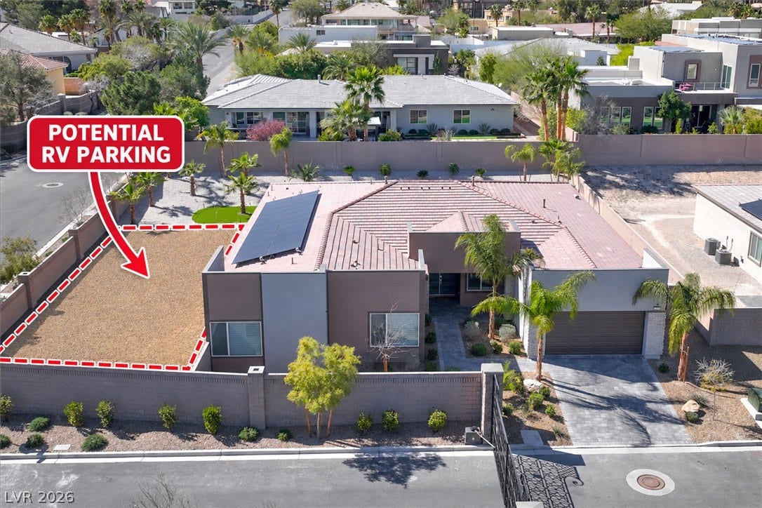 2689 Pioneer Estates Court, Las Vegas, NV 89117 Solar panels line the roof of this contemporary single-story home with desert landscaping.