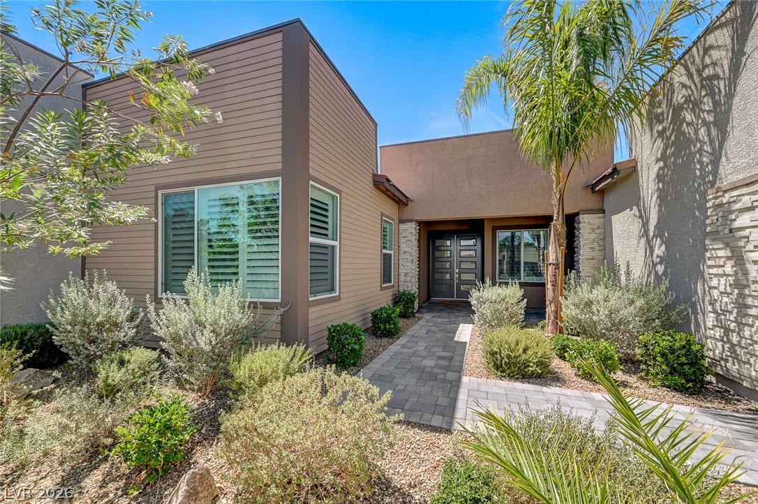 2689 Pioneer Estates Court, Las Vegas, NV 89117 A paved path leads through desert plantings to the entrance of this modern home.