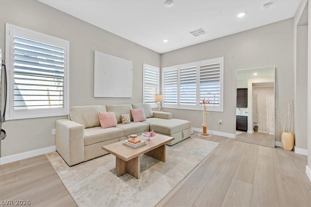 2689 Pioneer Estates Court, Las Vegas, NV 89117 High ceilings and wide-plank wood flooring elevate this inviting living space with plantation shutters.