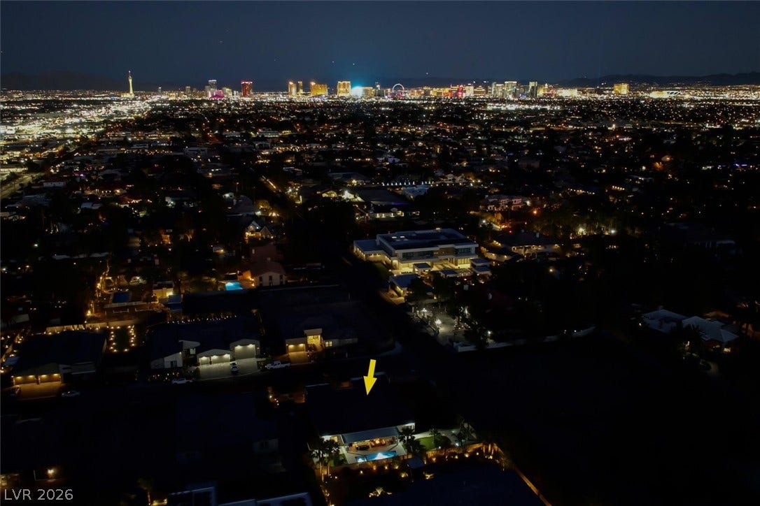 2689 Pioneer Estates Court, Las Vegas, NV 89117 Glittering city skyline views define this exceptional night perspective of the surrounding neighborhood.