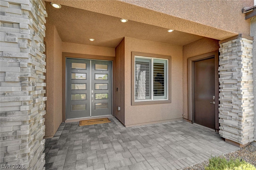 2689 Pioneer Estates Court, Las Vegas, NV 89117 Textured stone pillars and interlocking stone pavers frame this covered front entryway.