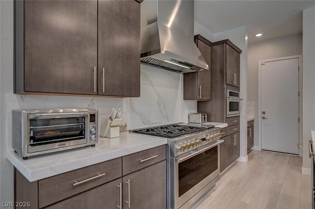 2689 Pioneer Estates Court, Las Vegas, NV 89117 Polished stone countertops complement flat-panel cabinetry and a professional-grade range.