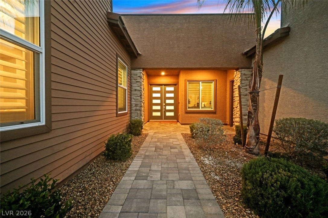 2689 Pioneer Estates Court, Las Vegas, NV 89117 A stone paver walkway leads to the welcoming double-door entrance of this modern home.