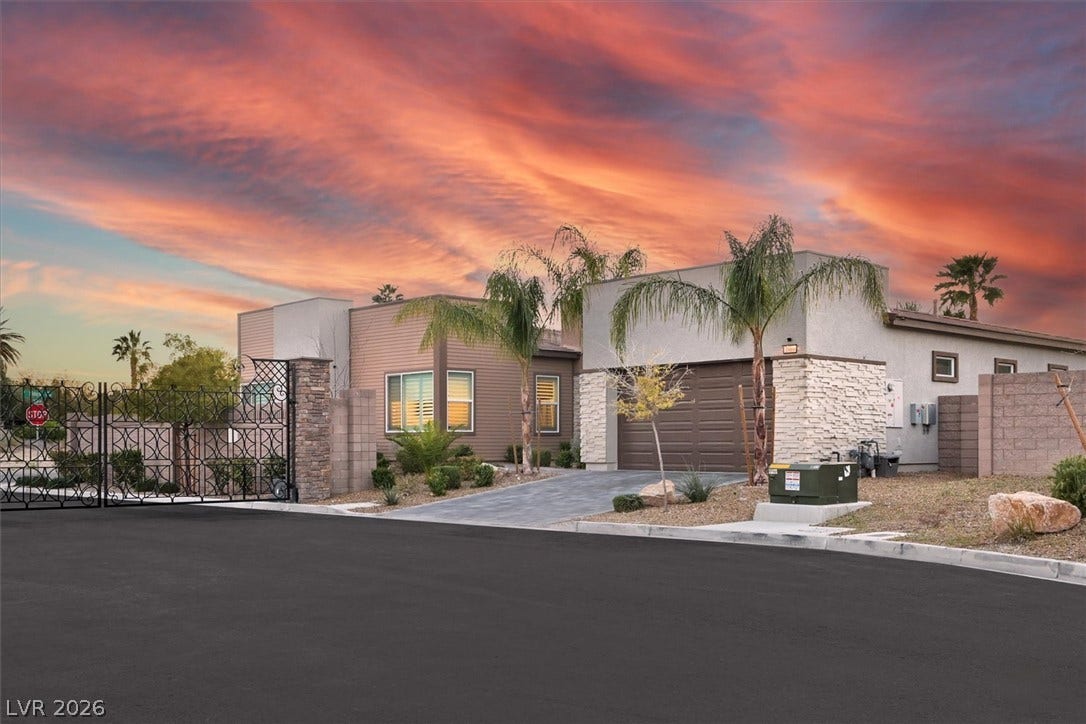 2689 Pioneer Estates Court, Las Vegas, NV 89117 Modern architecture pairs with stone accents and a private gated driveway under dramatic skies.