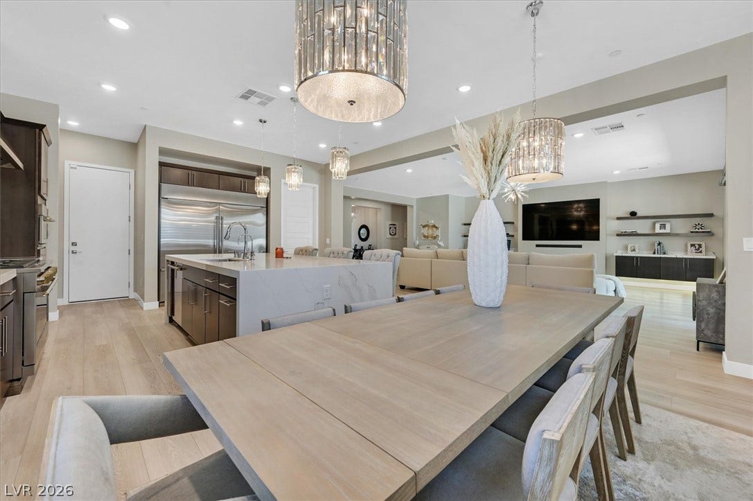 2689 Pioneer Estates Court, Las Vegas, NV 89117 An open floor plan seamlessly connects the kitchen and dining areas over warm hardwood floors.