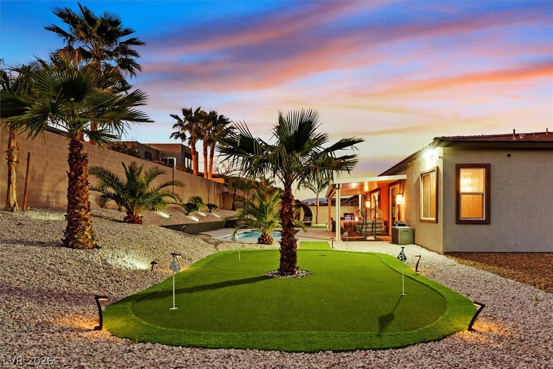 2689 Pioneer Estates Court, Las Vegas, NV 89117 Palm trees and a putting green frame the back of this single-story home.