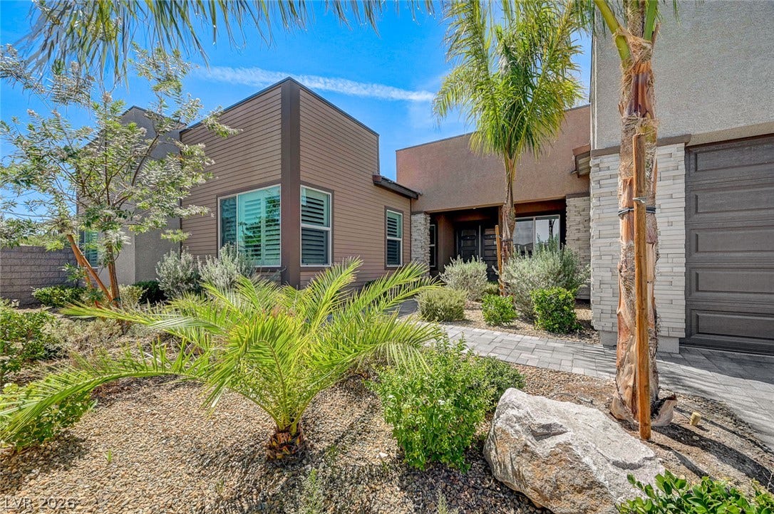 2689 Pioneer Estates Court, Las Vegas, NV 89117 Desert plantings line the paved walkway leading to the front entry of this modern residence.