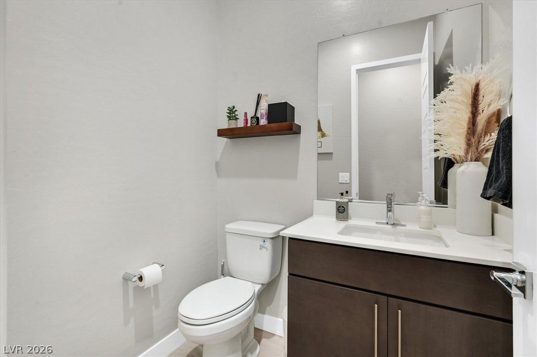 2689 Pioneer Estates Court, Las Vegas, NV 89117 A modern vanity with clean lines and quartz countertops elevates this minimalist powder room.