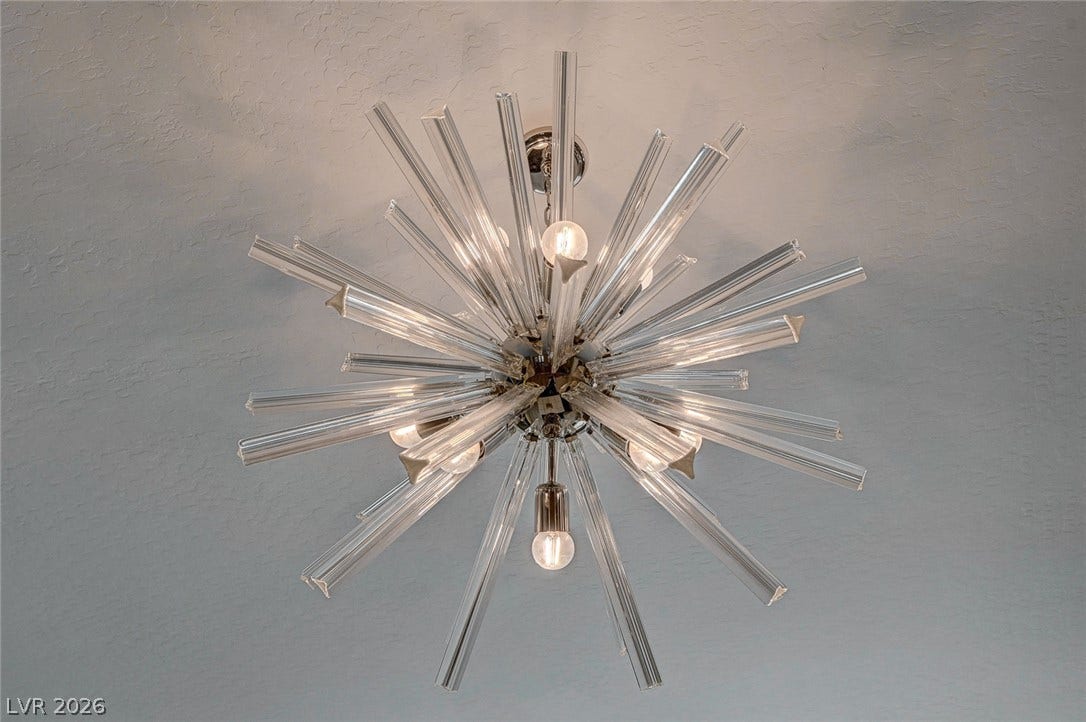 2689 Pioneer Estates Court, Las Vegas, NV 89117 An intricate sunburst light fixture anchors the textured ceiling with modern architectural detail.