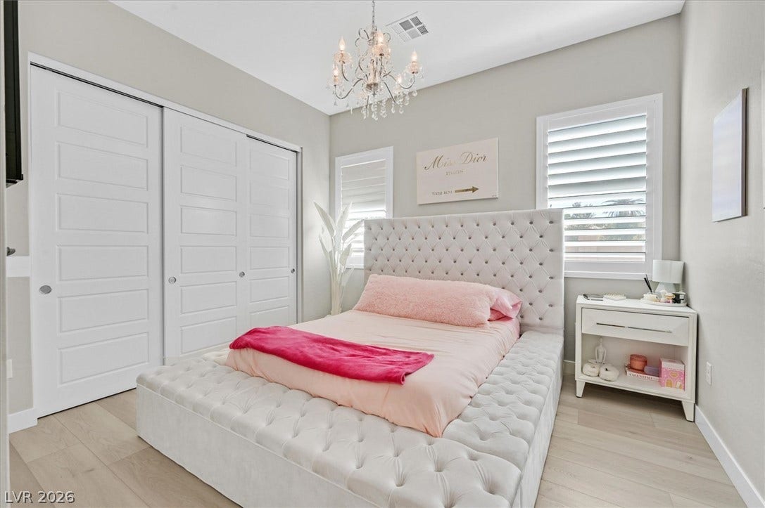 2689 Pioneer Estates Court, Las Vegas, NV 89117 Gleaming hardwood floors and classic plantation shutters enhance this serene bedroom space.