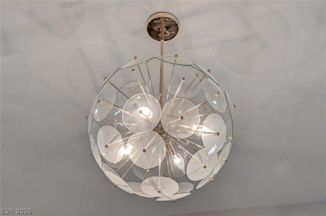 2689 Pioneer Estates Court, Las Vegas, NV 89117 An artistic spherical light fixture serves as a sculptural statement piece against the smooth ceiling.