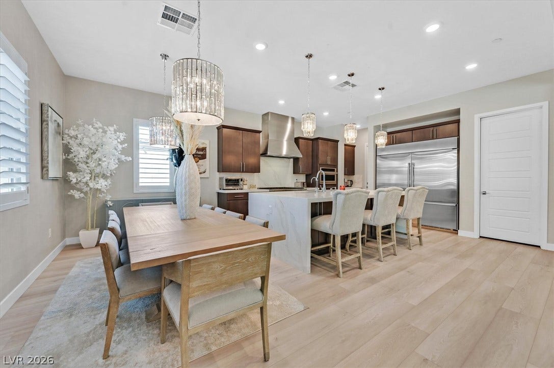 2689 Pioneer Estates Court, Las Vegas, NV 89117 Gleaming hardwood floors and a spacious stone-waterfall island anchor this modern open-concept space.
