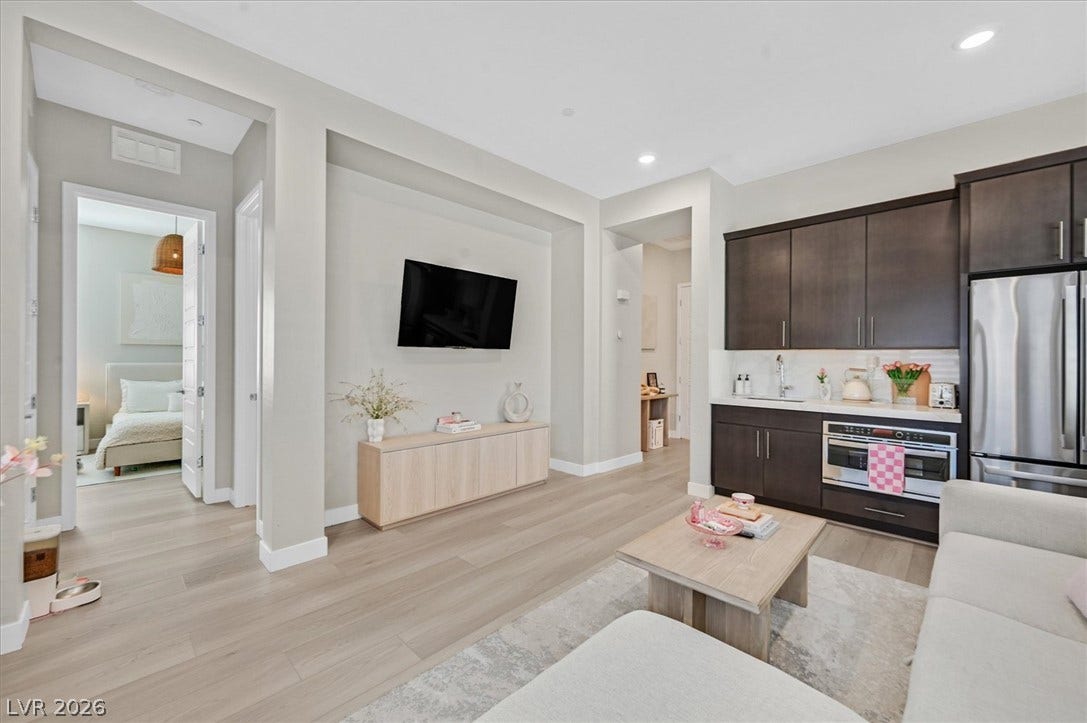 2689 Pioneer Estates Court, Las Vegas, NV 89117 An open floorplan design seamlessly connects this living space with a modern wet bar.