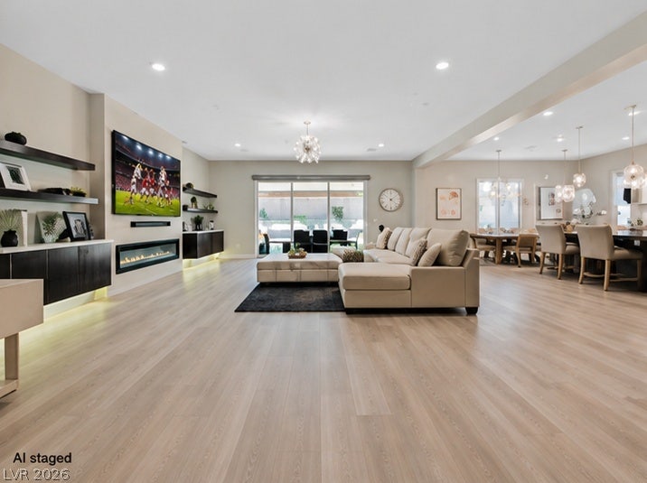 2689 Pioneer Estates Court, Las Vegas, NV 89117 A spacious layout showcases a modern linear fireplace and light wood flooring.