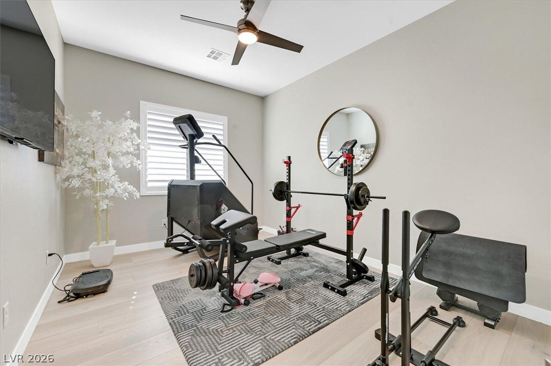 2689 Pioneer Estates Court, Las Vegas, NV 89117 Smooth wood floors and recessed window shutters define this versatile home recreation space.