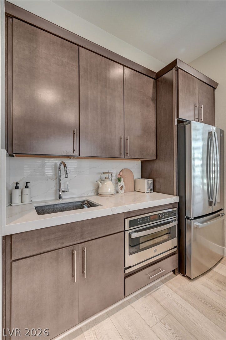 2689 Pioneer Estates Court, Las Vegas, NV 89117 Streamlined cabinetry and premium appliances define this elegant culinary workspace.