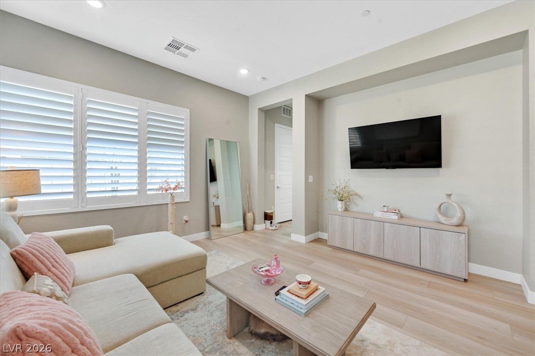 2689 Pioneer Estates Court, Las Vegas, NV 89117 Recessed lighting and warm wood flooring enhance this modern living space.
