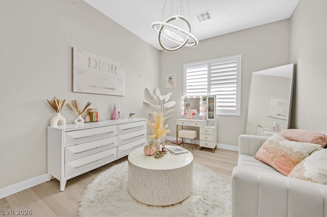 2689 Pioneer Estates Court, Las Vegas, NV 89117 Gleaming hardwood floors and a modern light fixture elevate this versatile living space.
