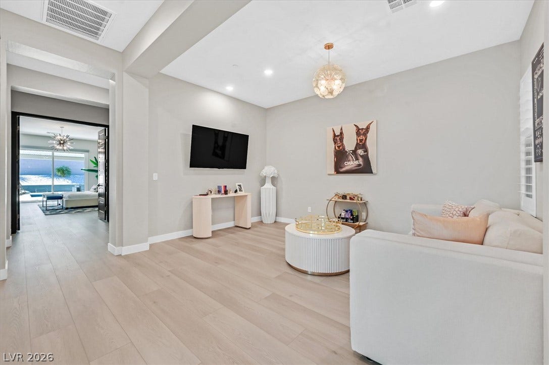 2689 Pioneer Estates Court, Las Vegas, NV 89117 Gleaming hardwood floors and a recessed ceiling establish a refined tone in this open living area.