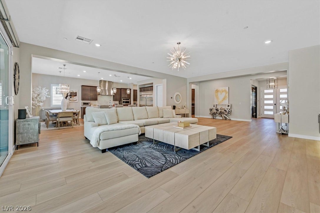 2689 Pioneer Estates Court, Las Vegas, NV 89117 Gleaming hardwood floors and a modern open floorplan connect the main living areas seamlessly.