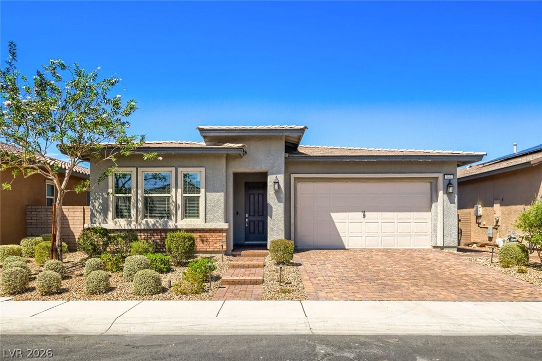 647 Longfeather Street, Henderson, NV 89011 An inviting exterior features a paved driveway leading to a two-car garage.