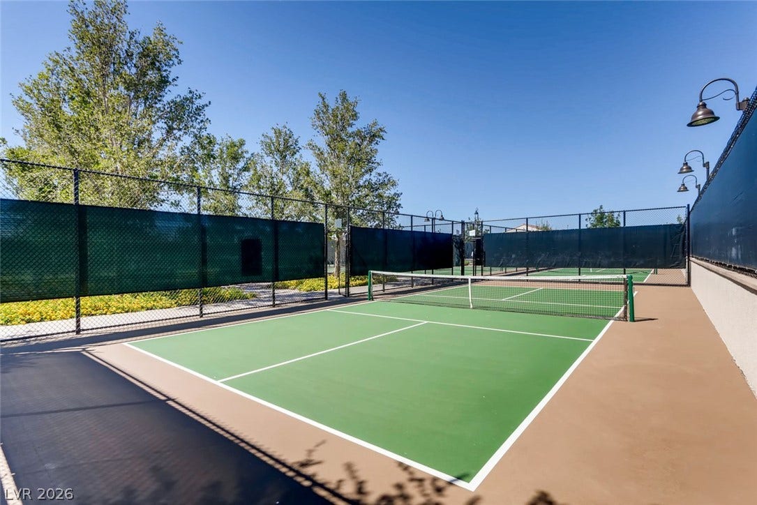 647 Longfeather Street, Henderson, NV 89011 Professional-grade outdoor tennis courts stand ready for play under clear blue skies.