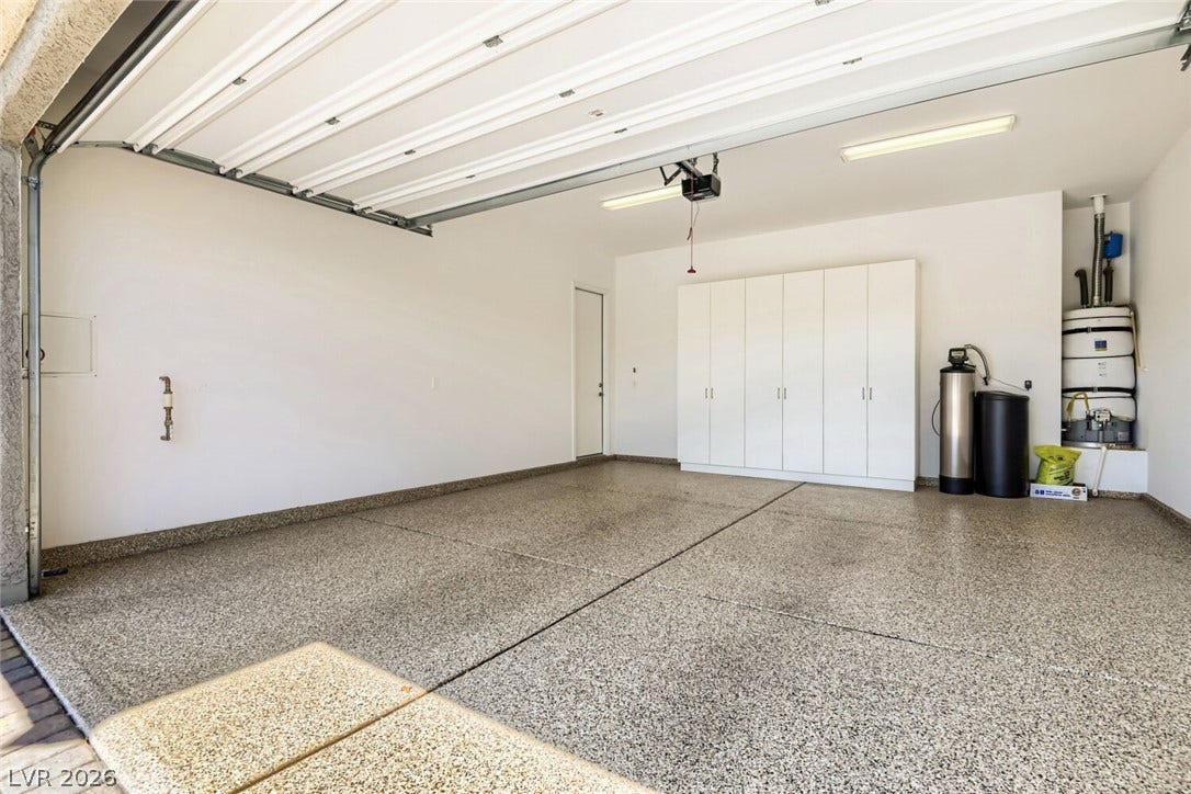 647 Longfeather Street, Henderson, NV 89011 An immaculate garage features durable epoxy flooring and extensive built-in storage cabinets.